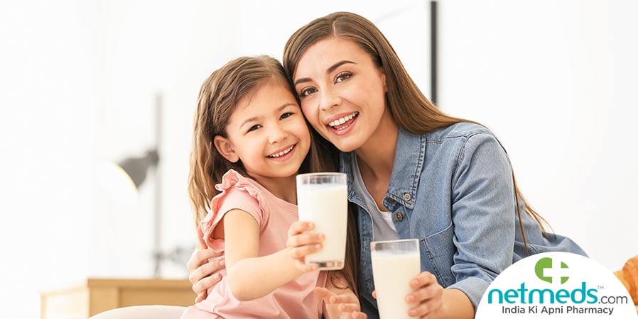 Mother and daughter drinking milk