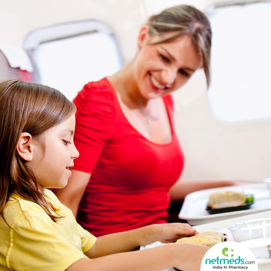Mom and daughter eating while travelling in flight 