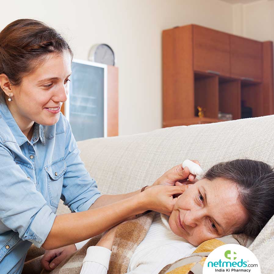 Woman using ear drops 
