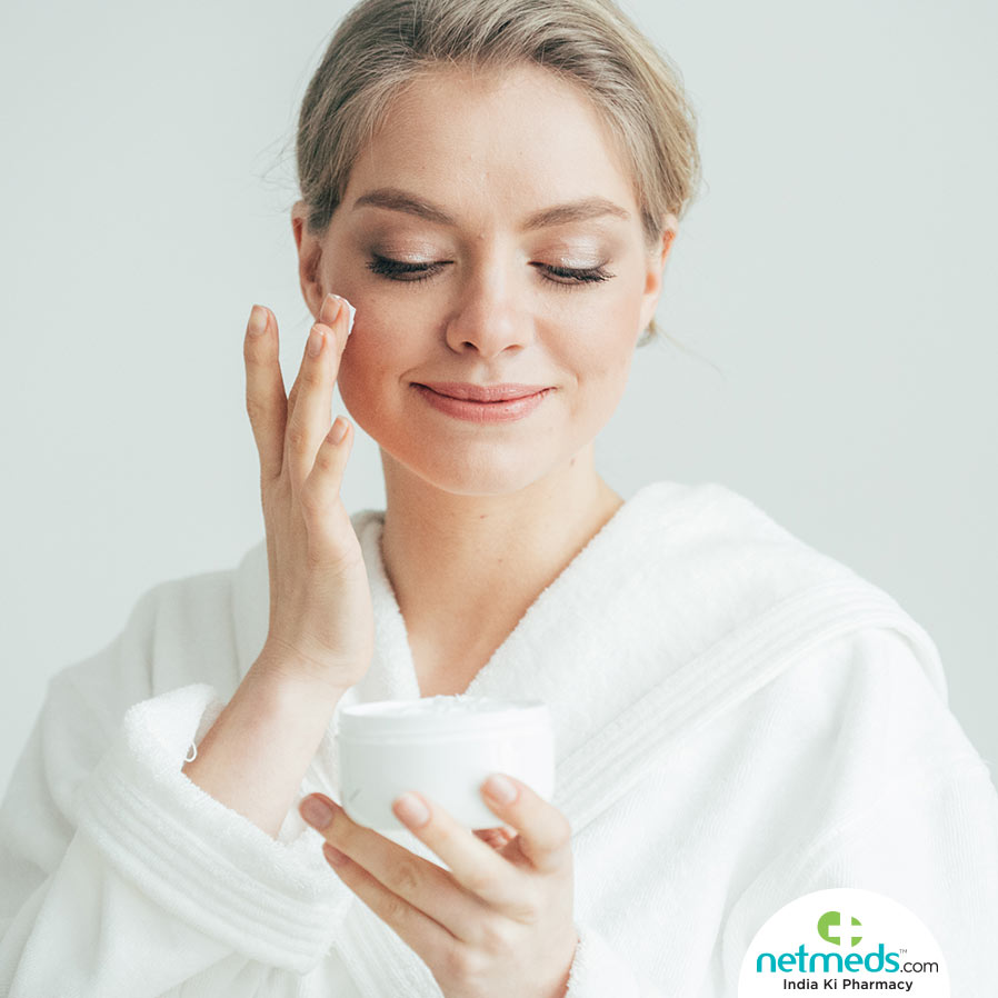 Woman applying face cream