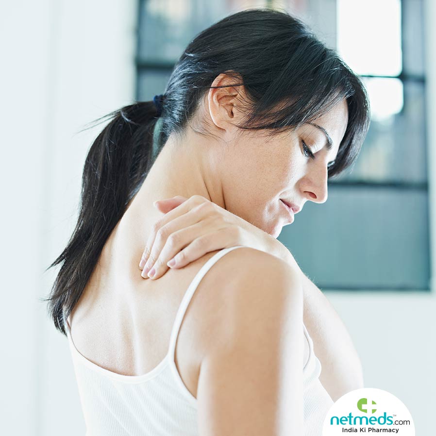 Woman holding her shoulder