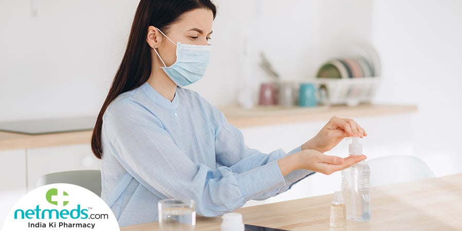 Woman using hand sanitizer