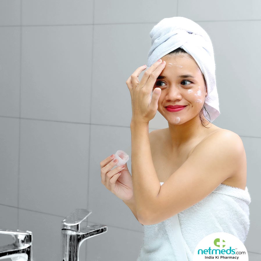 Woman applying face cream