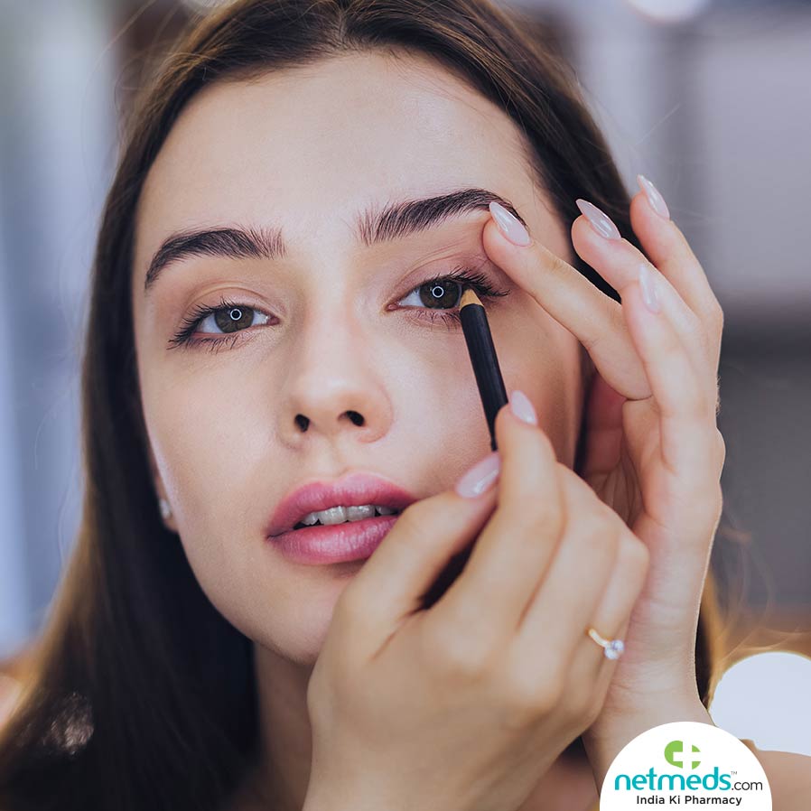 Woman applying eye make-up 