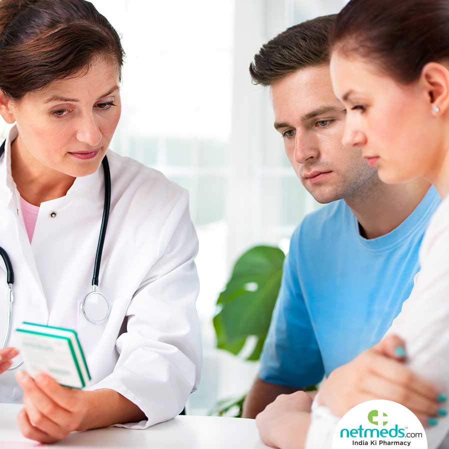 Doctor Giving Tips For Infertility Treatment To The Couple