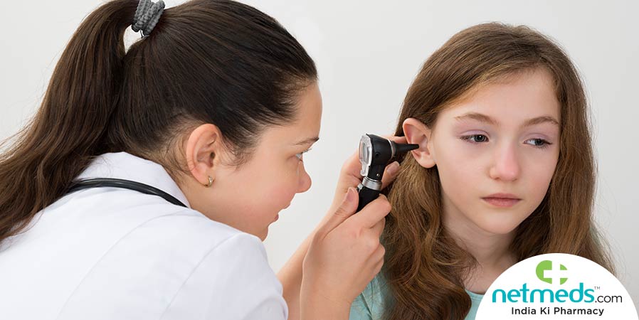 Doctor checking the ear of a child