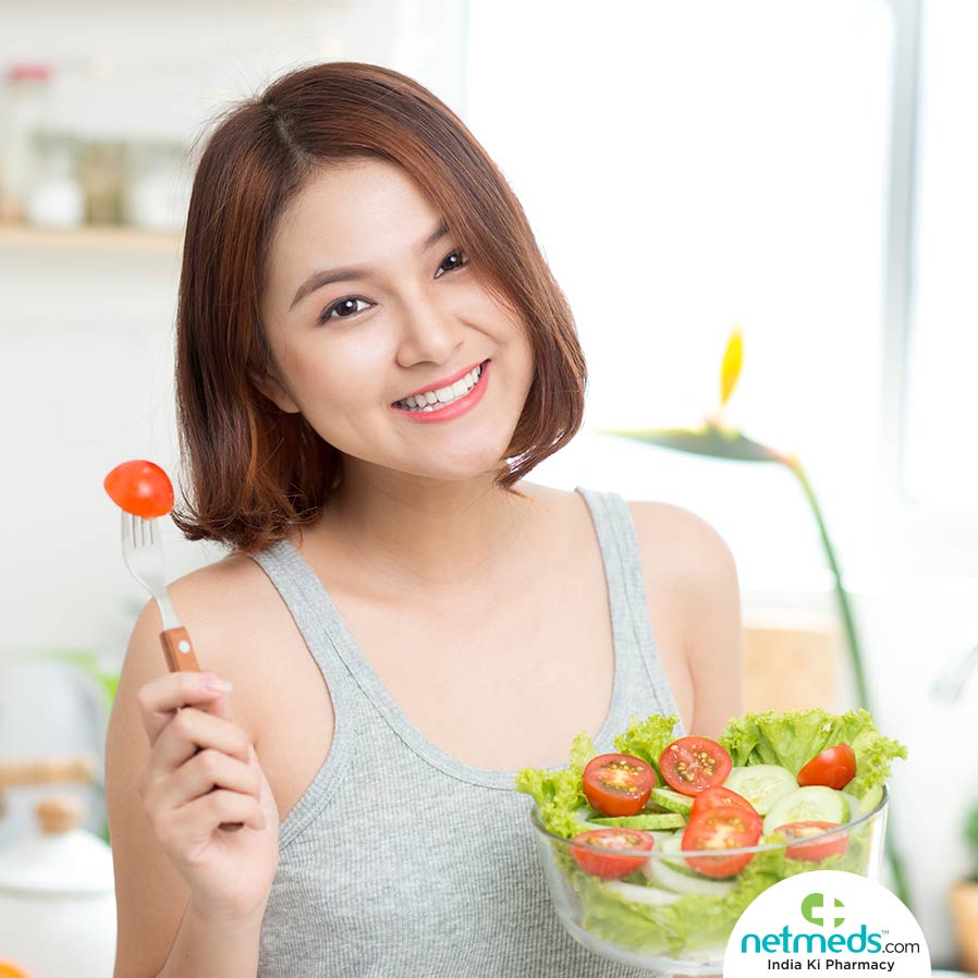 Woman eating vegetables