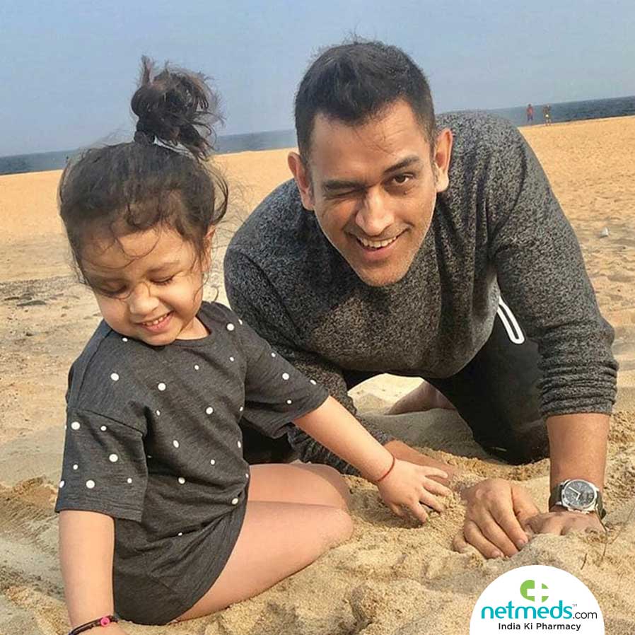 Dhoni playing with his daughter Ziva
