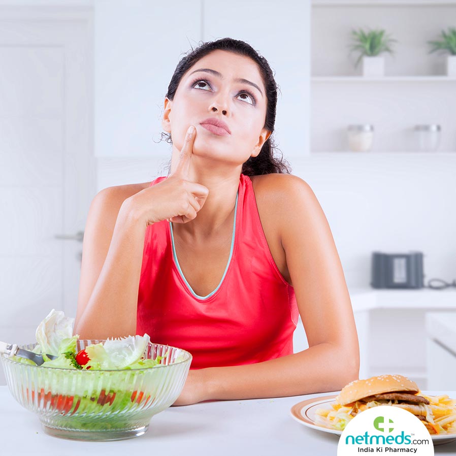 Girl thinking which to choose, healthy diet or junk food