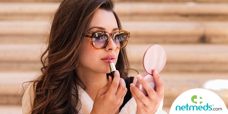 Woman applying lipstick