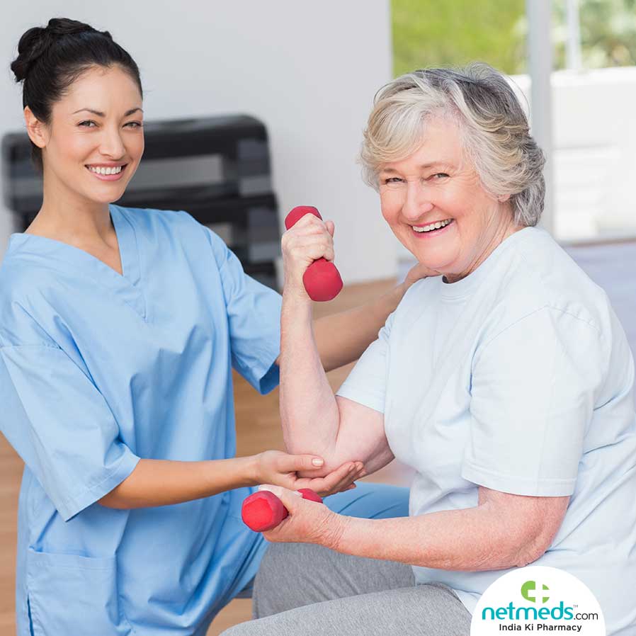 Old woman exercising with a nurse